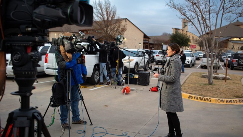 Local and national media, along with police, crowd the parking lot at Good Shepherd Catholic Church in Colleyville, Texas, Jan. 15, 2022, after four hostages were taken during services at nearby Congregation Beth Israel. After about an 11-hour standoff with an FBI crisis response team on the scene, the incident at the synagogue ended with the hostages' release and the hostage-taker being fatally shot. (CNS photo/Kevin Bartram, North Texas Catholic Magazine)