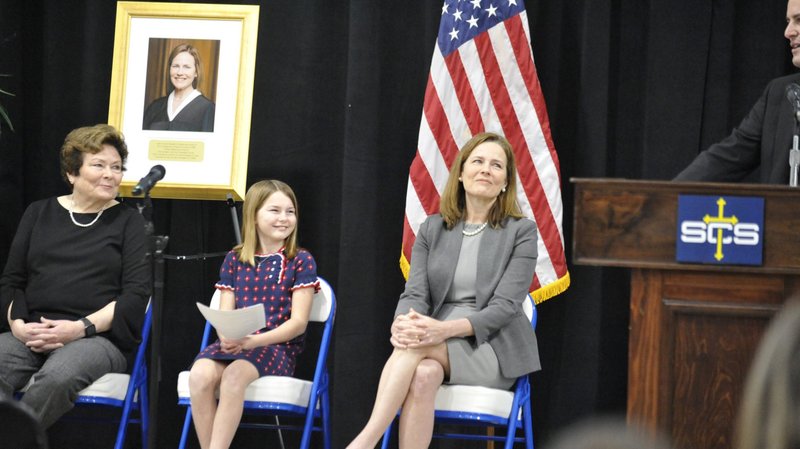 Father Tim Hedrick, pastor of St. Catherine of Siena Parish in Metairie, La., welcomes U.S. Supreme Court Associate Justice Amy Coney Barrett after her speech to the Catholic school Jan. 24, 2022. Barrett was joined by her mother, Linda, far left, and her 11-year-old daughter, Juliet, who asked the questions provided by students at the school. (CNS photo/Peter Finney Jr., Clarion Herald New Orleans)