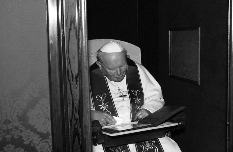 Pope John Paul II gives confession at St Peter's Basilica on April 9, 2004, in Vatican City. (Arturo Mari/Vatican Pool, Getty)