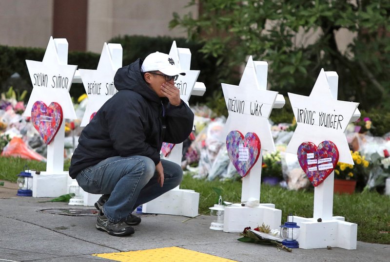 A young man reacts Oct. 29 at a makeshift memorial outside the Tree of Life synagogue in Pittsburgh. (CNS photo/Cathal McNaughton, Reuters)
