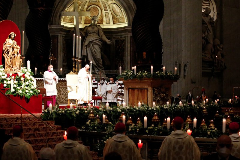 Pope Francis holds a candle as he celebrates Mass marking the feast of the Presentation of the Lord in St. Peter's Basilica at the Vatican Feb. 2, 2022. The Mass also marked the Vatican celebration of the World Day for Consecrated Life. (CNS photo/Remo Casilli, Reuters)