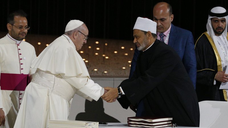 Pope Francis shakes hands with Sheikh Ahmad el-Tayeb, grand imam of Egypt's Al-Azhar mosque and university, during a document signing at an interreligious meeting in Abu Dhabi, United Arab Emirates, in this Feb. 4, 2019, file photo. The pope, Sheikh el-Tayeb and U.S. President Biden marked the International Day of Human Fraternity Feb. 4 on the anniversary of the 2019 meeting in Abu Dhabi. (CNS photo/Paul Haring)