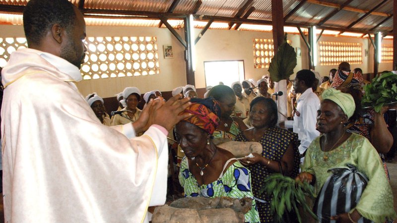A priest is pictured in a file photo accepting offertory gifts during Mass at St. Therese of the Child Jesus Catholic Church in Yaounde, Cameroon. The Vatican's Central Office of Church Statistics says global Catholic population has reached 1.36 billion, with largest percentage of growth in Africa and Asia. (CNS photo/Saabi, Galbe.Com)