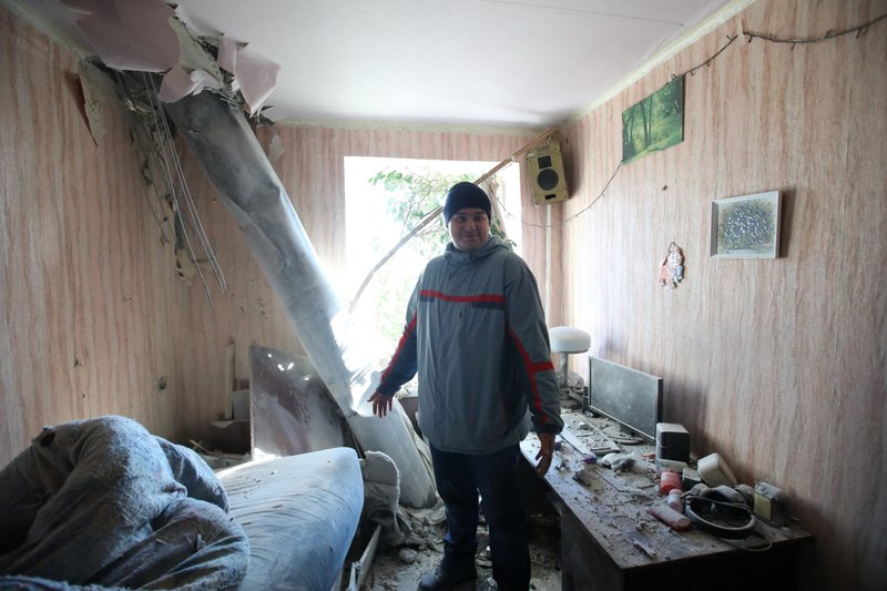 A resident stands amid debris in an apartment hit by shelling in Kharkiv, Ukraine, Feb. 24, 2022, after Russian President Vladimir Putin authorized a military operation in Ukraine. (CNS photo/Vyacheslav Madiyevskyy, Reuters)
