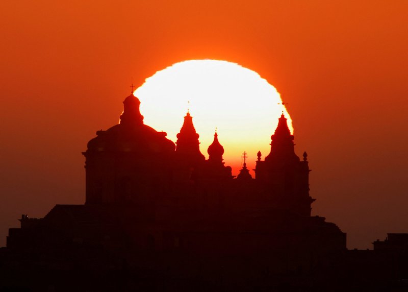 The sun rises behind the Metropolitan Cathedral of St. Paul in the medieval fortified city of Mdina, Malta, in this Jan. 2, 2022, file photo. The Vatican has released Pope Francis' schedule for his April 2-3 trip to Malta. (CNS photo/Darrin Zammit Lupi, Reuters)