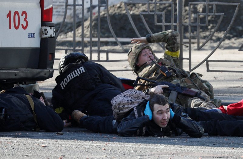 Military personnel and citizens take cover during shelling in Kyiv, Ukraine, Feb. 26, 2022. Russian troops stormed toward Ukraine's capital, and street fighting broke out as city officials urged residents to take shelter. (CNS photo/Gleb Garanich, Reuters)