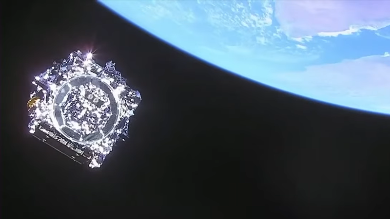 The James Webb Space Telescope seen approximately 29 minutes after launch. Part of the Earth with the Gulf of Aden can be seen in the background. (Screenshot via YouTube/NASA)