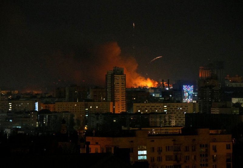 Smoke and flames can be seen during shelling in Kyiv, Ukraine, Feb. 26, 2022. Russian troops stormed toward Ukraine's capital, and street fighting broke out as city officials urged residents to take shelter. (CNS photo/Gleb Garanich, Reuters)
