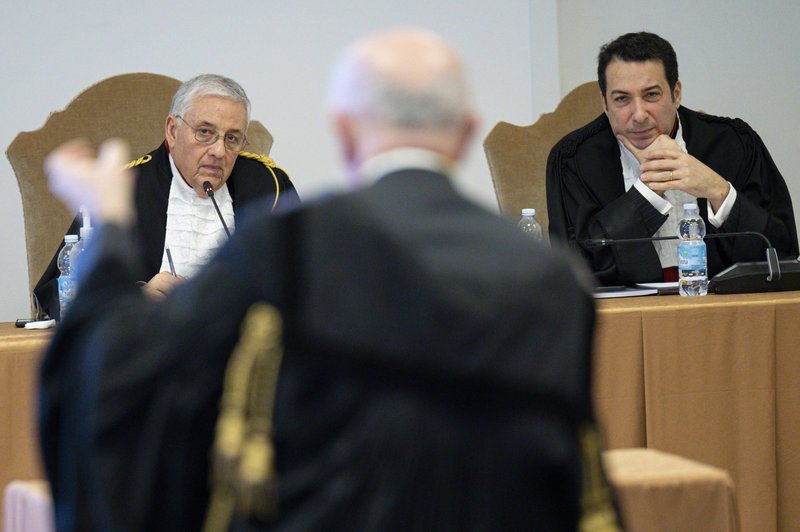Two of the four judges of the Vatican City State criminal court -- Giuseppe Pignatone and Carlo Bonzano -- listen during the ninth session of the trial of 10 defendants accused of financial crimes, at the Vatican City State criminal court March 1, 2022. Vatican judges rejected defense lawyers' request to dismiss charges after prosecutors said the Vatican lost millions of euros in a controversial property deal that is at the heart of a massive Vatican trial for financial malfeasance. (CNS photo/Simone Risoluti, Vatican Media)