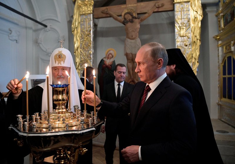 Russian Orthodox Patriarch Kirill of Moscow and Russian President Vladimir Putin place candles while visiting the New Jerusalem Monastery in Istra, outside of Moscow, in this Nov. 15, 2017, file photo. Church leaders have appealed to Patriarch Kirill to intervene and ask President Putin to stop the bloodshed in Ukraine. (CNS photo/Sputnik/Alexei Nikolsky/Kremlin via Reuters)