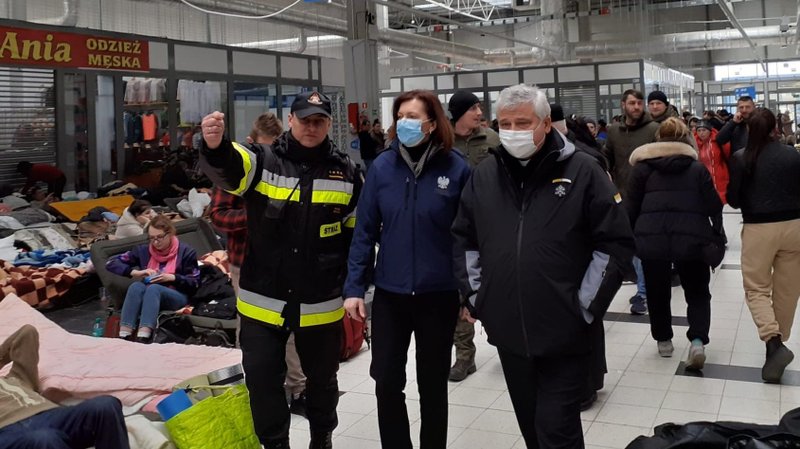 Cardinal Konrad Krajewski, the papal almoner, visits Ukrainian refugees in Korczowa, Poland, March 8, 2022, at a supermarket that was turned into a temporary refugee center. (CNS photo)