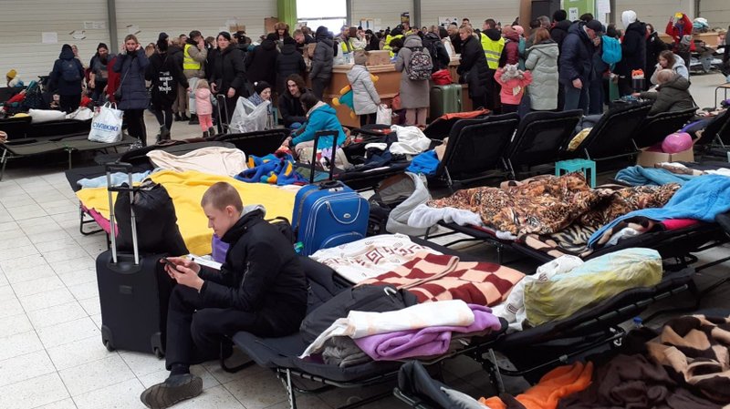 Ukrainian refugees are pictured in a supermarket that was turned into a refugee center in Korczowa, Poland, March 8, 2022. (CNS photo)