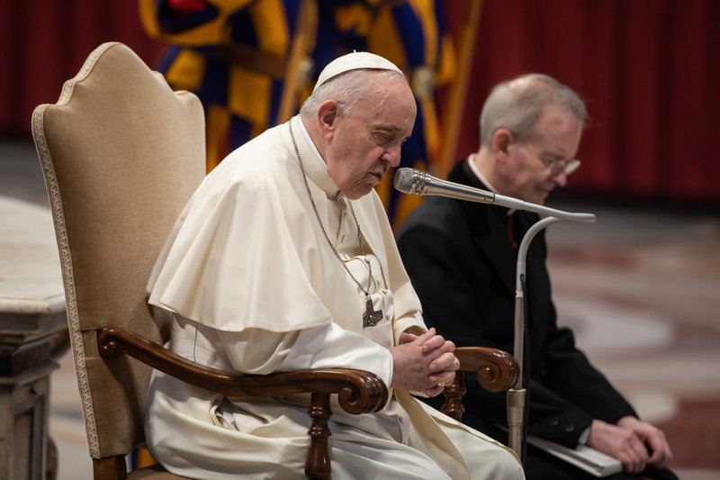 Pope Francis prays during a meeting with students from Milan in St. Peter's Basilica at the Vatican March 16, 2022. The pope prayed for children in Ukraine who are forced to flee from bombings. (CNS photo/Stefano Dal Pozzolo, pool)