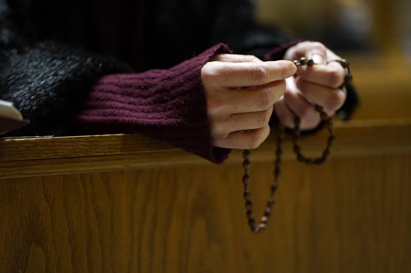 A woman prays the rosary following an evening prayer service at St. George Ukrainian Catholic Church in New York City Jan. 26, 2022. The pope has invited "every community and every believer" to join him in consecrating and entrusting Russia and Ukraine to Mary March 25. (CNS photo/Gregory A. Shemitz)