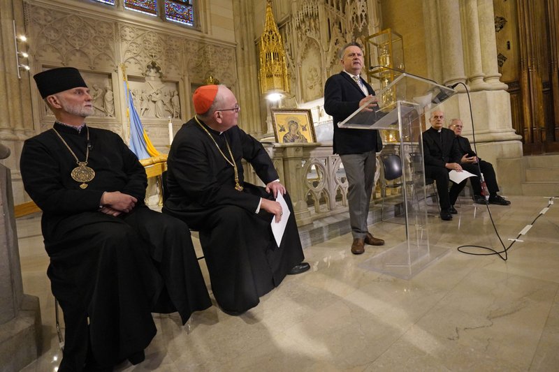 Sergiy Kyslytsya, Ukraine's ambassador to the United Nations, speaks during a news conference addressing the state of affairs in war-ravaged Ukraine March 24, 2022, at St. Patrick's Cathedral in New York City. Looking on are Archbishop Borys Gudziak, left, of the Ukrainian Catholic Archeparchy of Philadelphia and New York Cardinal Timothy M. Dolan. (CNS photo/Gregory A. Shemitz)