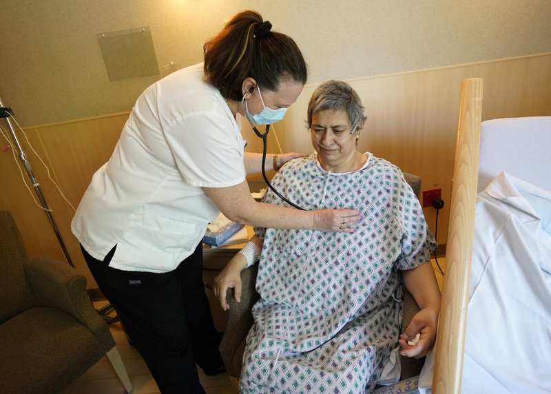 Jenette Jaeckel, registered nurse, uses a stethoscope while examining patient Diana Nappo at Catholic Health's Good Shepherd Hospice site in Port Jefferson, N.Y., May 6, 2021, National Nurses Day. (CNS photo/Gregory A. Shemitz)