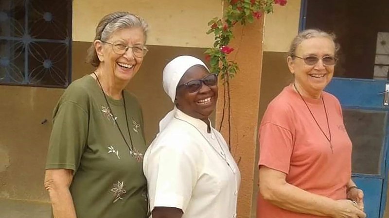 Three Marianite Sisters: Suellen Tennyson, Pascaline Tougma and Pauline Dourin, are pictured in an undated photo near the clinic where they serve in Yago, Burkina Faso. Sister Tennyson, 83, an American, was kidnapped late April 4 or early April 5 after armed attackers broke into the convent on the parish compound. (CNS photo/courtesy Marianites of the Holy Cross)