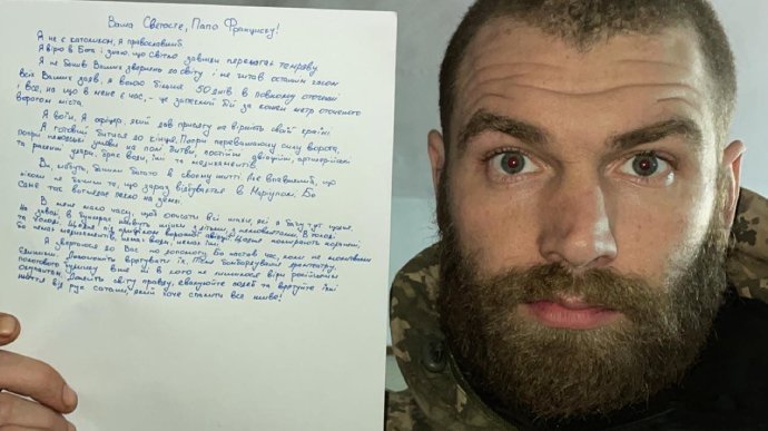 Maj. Serhiy Volyna, commander of Ukraine's 36th Separate Marine Brigade, holds a letter he wrote to Pope Francis. In his letter, published April 18, 2022, by the Ukrainian online newspaper Pravda, Volyna pleaded with the pope to save the people of Mariupol. (CNS photo/Ukrainska Pravda)