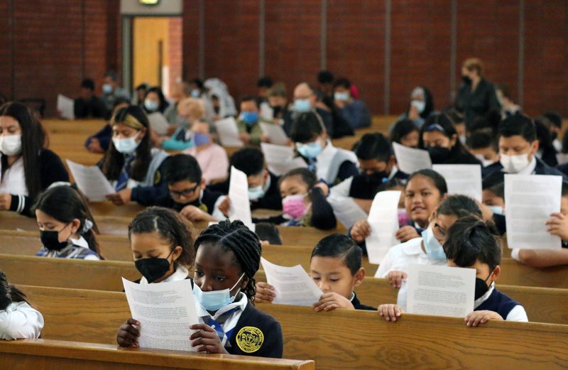 Students at St. Anthony of Padua School in Gardena pray during Mass on March 25, 2022. (Pablo Kay)