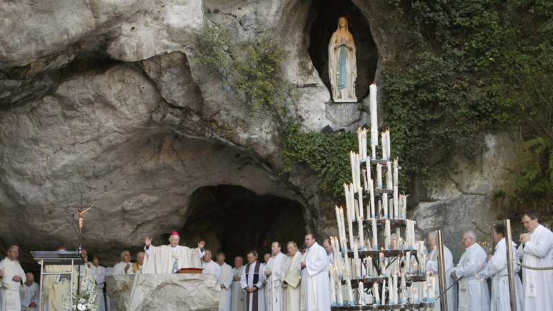 Mass is celebrated in the grotto at the Shrine of Our Lady of Lourdes in France in this file photo. (CNS photo/Nancy Wiechec)