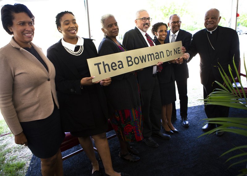 Washington Cardinal Wilton D. Gregory, right, and Mayor Muriel Bowser of the District of Columbia, left, participate in the dedication and blessing of Sister Thea Bowman Drive at The Catholic University of America in Washington April 29, 2022. Sister Bowman, who died in 1990, is one of six Black Catholics who are candidates for sainthood. Her sainthood cause was opened in 2018 and she has the title "Servant of God." (CNS photo/Tyler Orsburn)