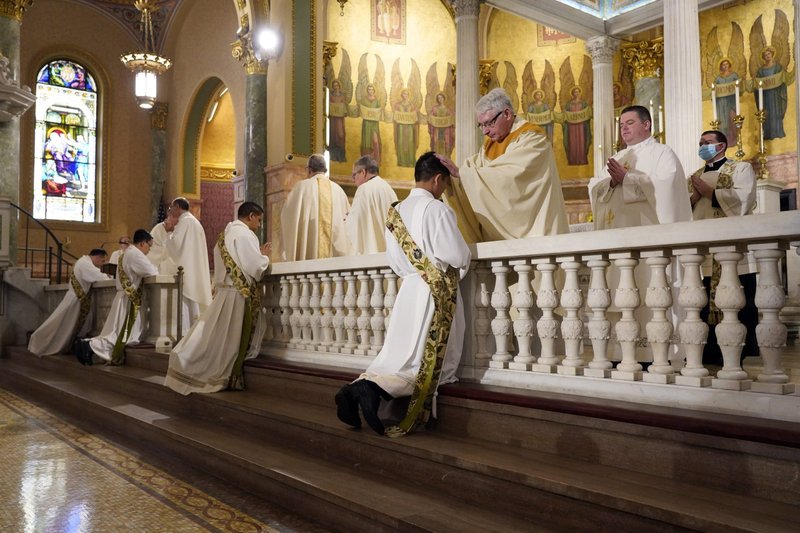 Four ordinands kneel as priests lay hands on them during their ordination to the priesthood June 5, 2021, at the Co-Cathedral of St. Joseph in Brooklyn, N.Y. (CNS photo/Gregory A. Shemitz)