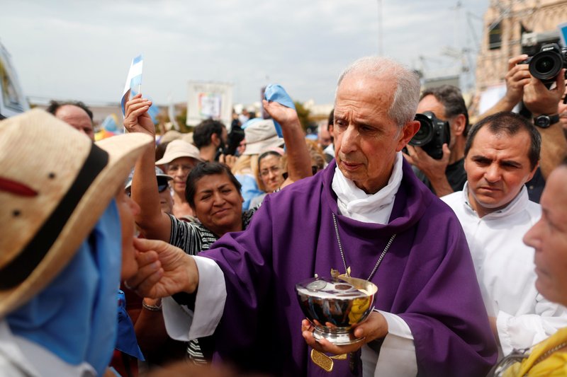 Cardinal Mario Poli of Buenos Aires, Argentina, distributes Communion during a Mass outside the Basilica of Our Lady of Lujan in Buenos Aires March 8, 2020. An audit ordered by the Vatican into the Archdiocese of Buenos Aires has revealed irregularities in the sales of church assets, but said no crimes were committed. (CNS photo/Agustin Marcarian, Reuters)