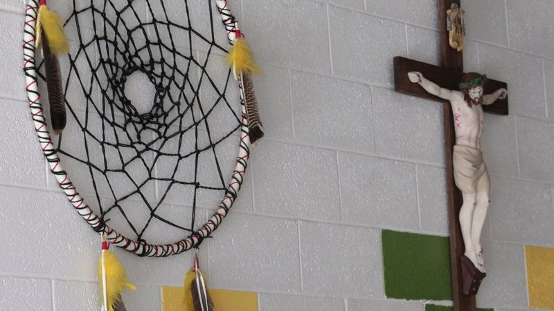 A dream catcher and crucifix are seen on the wall of a school on the Zuni Pueblo Indian reservation in New Mexico in this 2011 file photo. (CNS photo/Bob Roller)