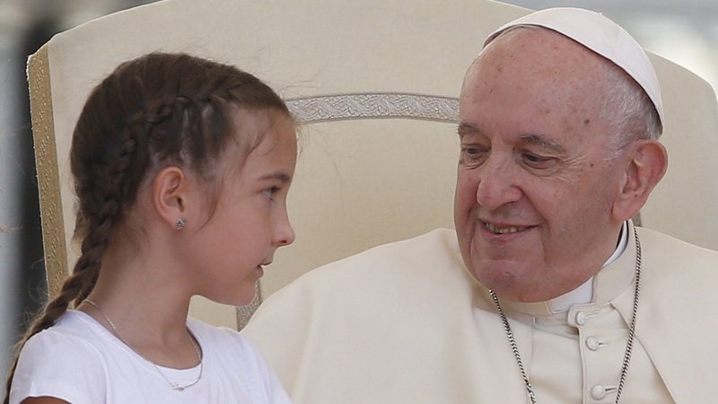 Pope Francis greets a girl during his general audience in St. Peter's Square at the Vatican May 25, 2022. (CNS photo/Paul Haring)