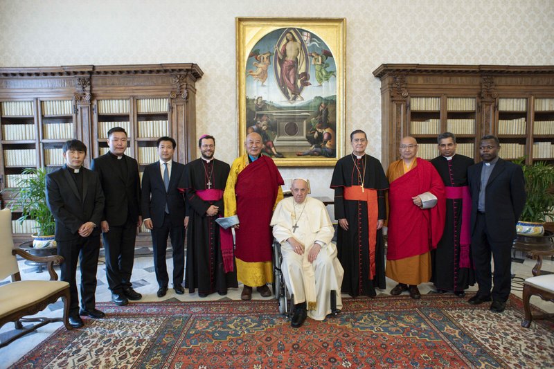 Pope Francis poses for group photo during an audience with Buddhist leaders from Mongolia at the Vatican May 28, 2022. Also present were Bishop Giorgio Marengo, apostolic prefect of Ulaanbaatar, Mongolia, who was named a cardinal by the pope May 29; and Cardinal Miguel Angel Ayuso Guixot, president of the Pontifical Council for Interreligious Dialogue. (CNS photo/Vatican Media)