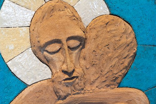 A relief sculpture of Jesus Christ embracing a person. Made out of modelling clay by Lubo Michalko. Displayed in the Quo Vadis Catholic House. (Adam Jan Figel / Shutterstock.com)