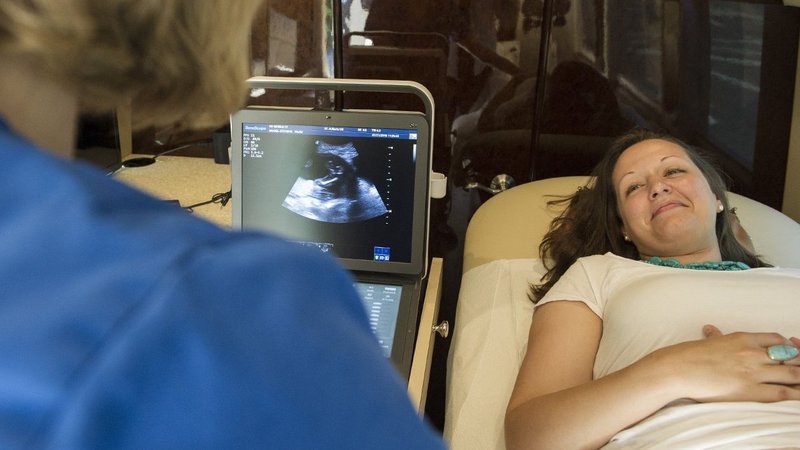A medical professional speaks with an expectant mother during an ultrasound examination in this 2016 photo. (CNS photo/Thomas Serafin, courtesy Knights of Columbus)