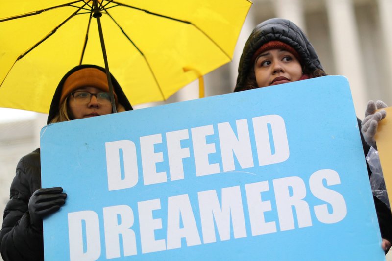 Supporters of Deferred Action for Childhood Arrivals hold signs outside the U.S. Supreme Court in Washington Nov. 12, 2019. Created by President Barack Obama via executive action, the DACA program marked its 10th anniversary June 15, 2022. It protects some young adults brought to the U.S. illegally as children from being deported. DACA beneficiaries are popularly known as "Dreamers." (CNS photo/Jonathan Ernst, Reuters)