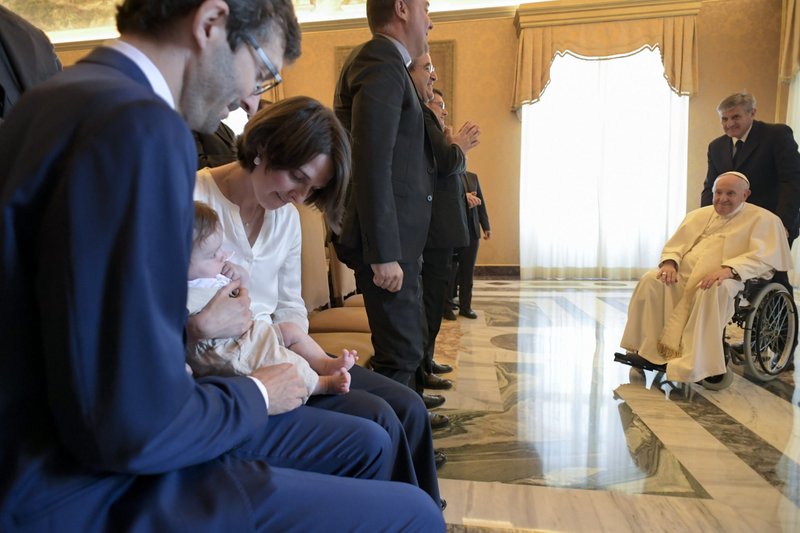 Pope Francis and a baby look at each other during an audience at the Vatican with the staff of Milan's archdiocesan seminary and its theology journal June 17, 2022. (CNS photo/Vatican Media)