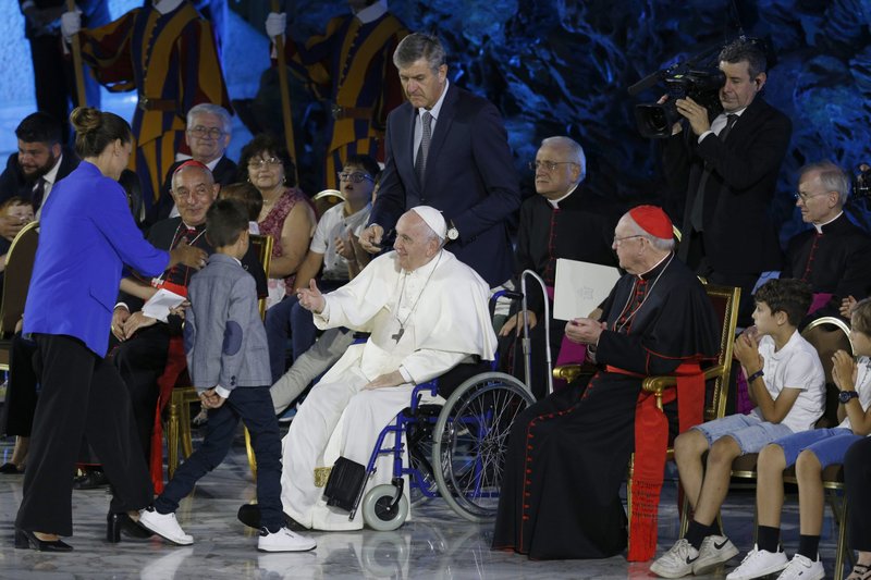 Pope Francis greets a woman and child as he opens the World Meeting of Families in the Paul VI hall at the Vatican June 22, 2022. The Festival of Families, an evening of sharing and music, was the opening event of the five-day meeting. (CNS photo/Paul Haring)