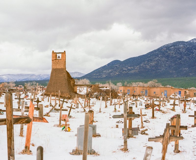 Crosses are seen in snow on the grounds of St. Jerome Catholic Chapel in Taos Pueblo, N.M., Nov. 29, 2019. St. Jerome is the patron saint of Taos Pueblo, where 90% of the Pueblo Indians are Catholic. The original church was destroyed by the U.S. Army in 1847 during the Mexican War, and the current church built to replace it was completed in 1850. (CNS photo/Isabelle Baldwin)