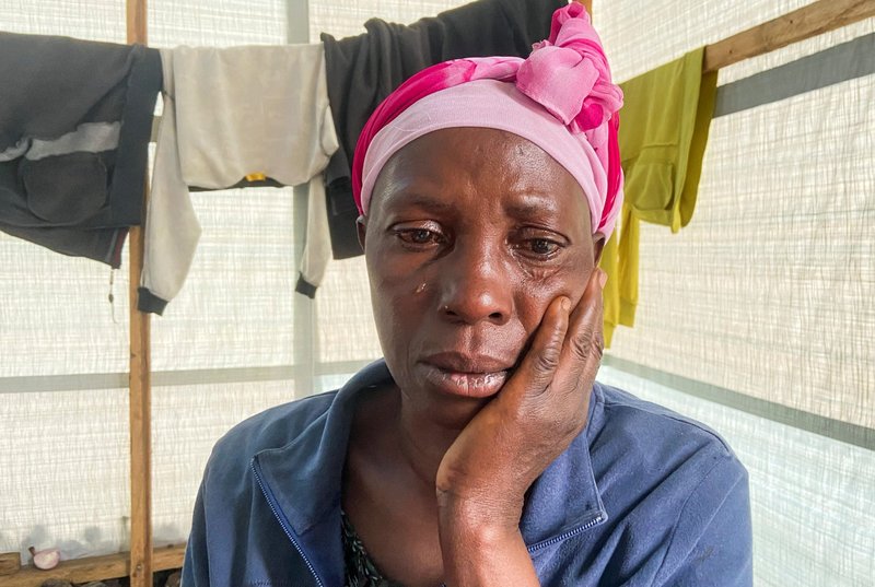 Kana Kajanga, 50, an internally displaced Congolese woman, cries inside a makeshift shelter at a church after fleeing renewed fighting near the Congolese border with Rwanda, outside Goma, Congo, on May 28. (CNS photo/Djaffar Sabiti, Reuters)