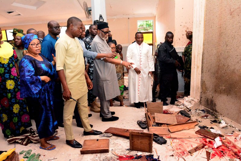 Local officials survey a bloodstained floor after the attack on St. Francis Church in Owo. (AFP via Getty Images)