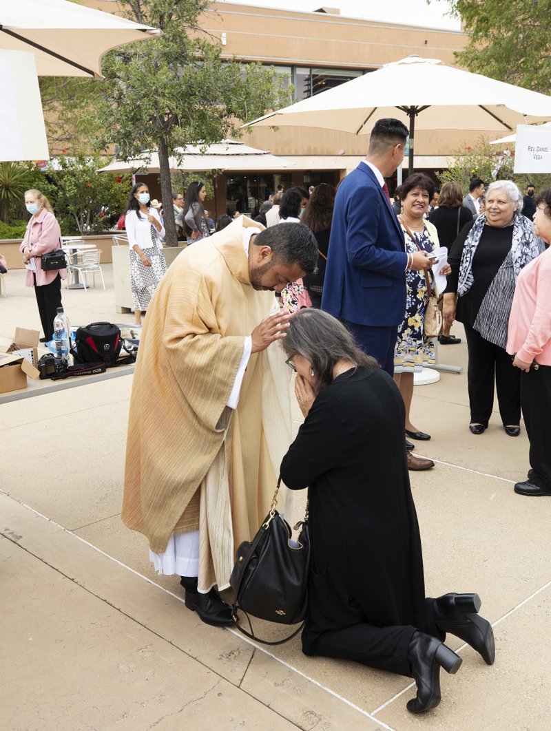 Father Juan Gutierrez gives a first blessing in the Plaza of the Cathedral of Our Lady of the Angels after his June 4, 2022 Ordination Mass. (Victor Alemán)