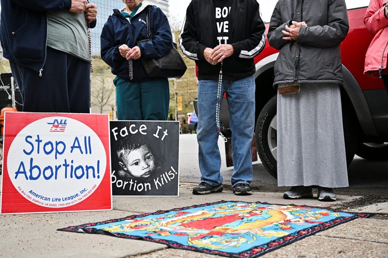 Pro-life demonstrators in Louisville, Ky., gather to pray outside the EMW Women's Surgical Center April 16, 2022, three days after the Kentucky Legislature overrode Gov. Andy Beshear's veto of a bill that bans most abortions after 15 weeks of pregnancy, restricts access to medication abortion and makes it more difficult for a minor to obtain an abortion in the state. State lawmakers gave final approval to the measure March 29. (CNS photo/Jonathan Cherry, Reuters)
