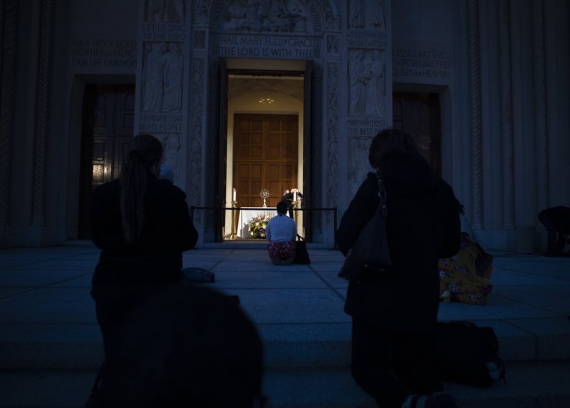 People pray during the exposition and adoration of the Blessed Sacrament at the Basilica of the National Shrine of the Immaculate Conception in Washington March 11, 2021, amid the coronavirus pandemic. (CNS photo/Tyler Orsburn)