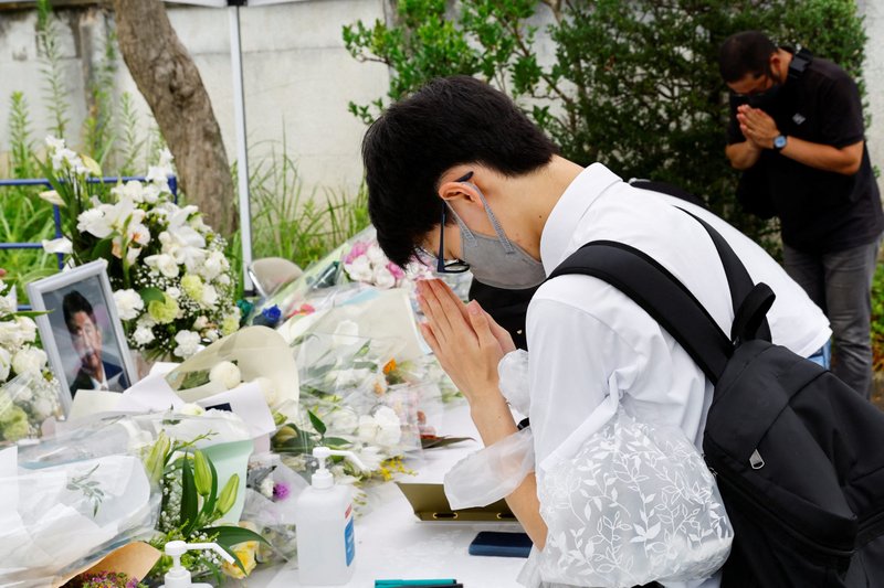 Mourners pray for the late former Japanese Prime Minister Shinzo Abe at the headquarters of the Japanese Liberal Democratic Party in Tokyo July 12, 2022. Archbishop Isao Kikuchi of Tokyo strongly condemned the July 8 assassination of Abe, and deplored violence as a means of solving political differences. (CNS photo/Kim Kyung-Hoon, Reuters)