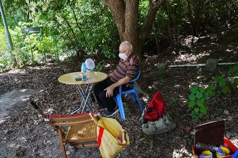 Father Franco Mella, a missionary with the Pontifical Institute of Foreign Missions, sits as he begins his hunger strike outside Shek Pik Prison in Hong Kong July 14, 2022. Father Mella is calling for freedom of all political prisoners. The Milan-born priest, who is a longtime rights activist in the Chinese-ruled city, vowed to refuse food as he stood on a dam wall overlooking the prison on an isolated stretch of Hong Kong's Lantau Island. (CNS photo/Lam Yik, Reuters)