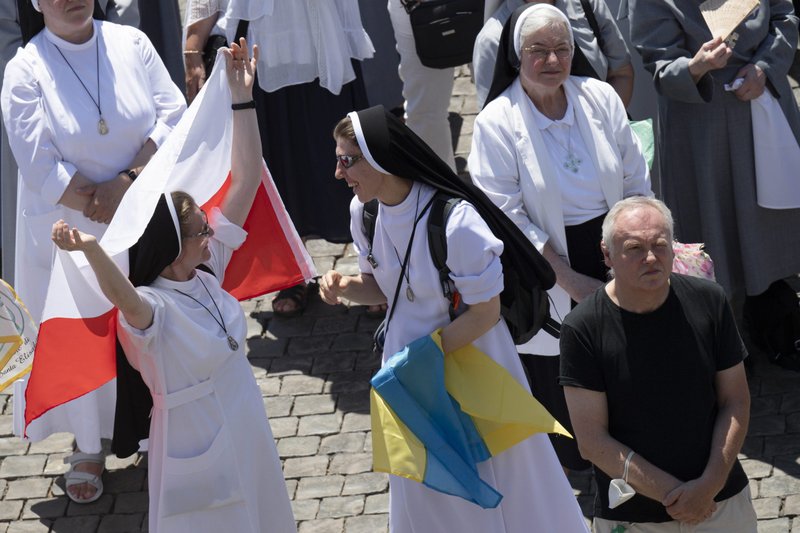 Nuns hold Polish and Ukrainian flags in St. Peter's Square as Pope Francis leads the Angelus from the window of his studio overlooking the square at the Vatican July 17, 2022. (CNS photo/Vatican Media)