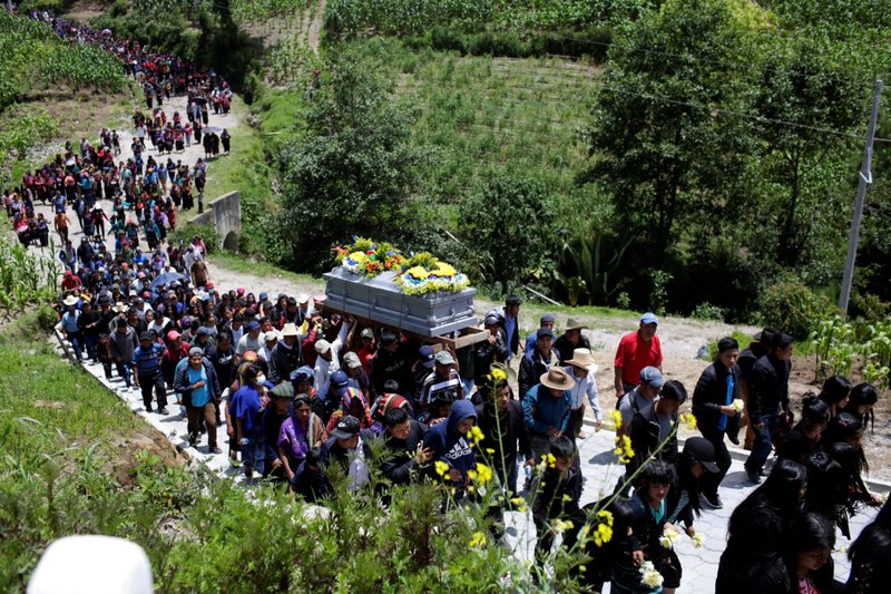 Relatives and friends carry the coffin containing the body of Pascual Melvin Guachiac, 13, during his funeral in the small village of Tzucubal in Nahuala, Guatemala, July 16, 2022 The teen died June 27 when he suffocated while being smuggled in a semitrailer in San Antonio. He was one of 53 migrants found dead in the truck's cargo area. (CNS photo/Sandra Sebastian, Reuters)