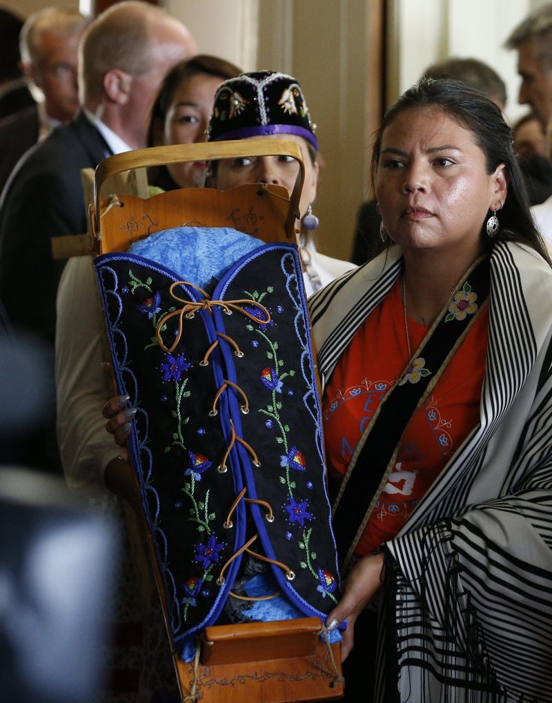 An Indigenous woman displays a cradleboard as Pope Francis meets with a delegation of Indigenous peoples in the archbishop's residence in Quebec City July 29, 2022. Indigenous leaders want Pope Francis to help them get information about the more than 4,000 children who died at Canada's residential schools and the thousands of others who never returned home from the schools. (CNS photo/Paul Haring)