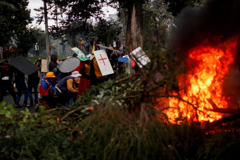 Demonstrators in Quito, Ecuador, use makeshift shields during an anti-government protest June 23, 2022, amid a stalemate between the government of President Guillermo Lasso and largely Indigenous demonstrators who demand an end to emergency measures. (CNS photo/Adriano Machado, Reuters)