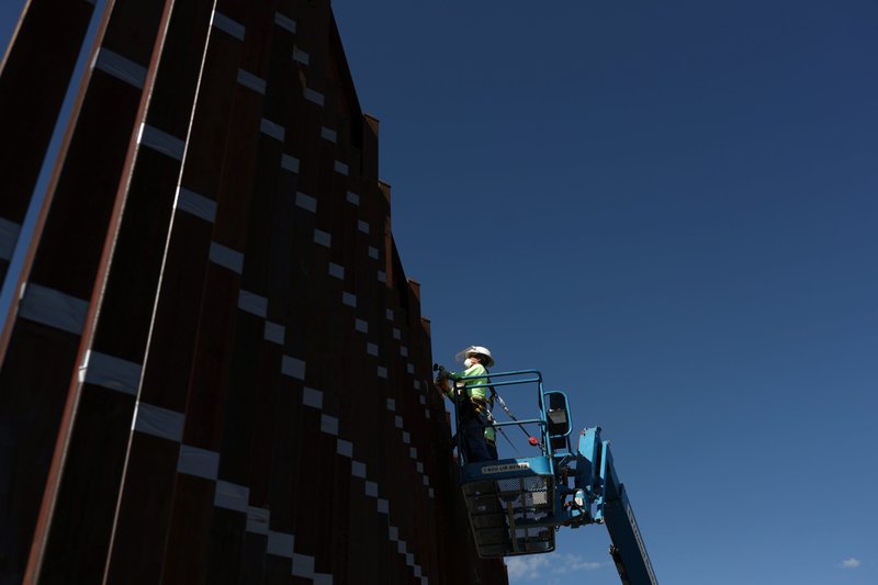 Contractors in Nogales, Ariz., prepare to paint the wall along the U.S.-Mexico border Sept. 13, 2018. (CNS photo/Adrees Latif, Reuters)