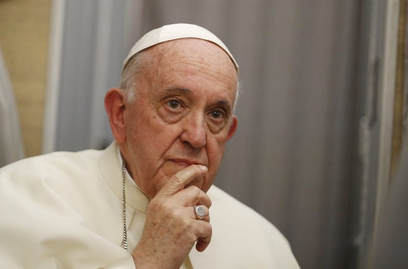 Pope Francis looks on as he answers questions from journalists aboard his flight from Iqaluit, Nunavut, to Rome July 29, 2022. During the news conference, the pope highlighted the words of a fifth-century monk, St. Vincent of Lérins, about proper doctrinal development. (CNS photo/Paul Haring)