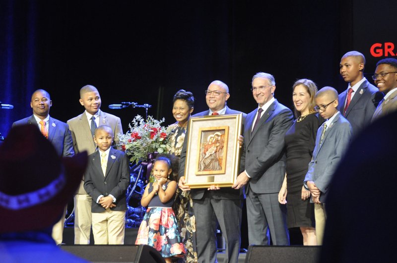 Supreme Knight Patrick E. Kelly, CEO of the Knights of Columbus, presents the International Family of the Year Award Aug.1, 2022, to the Sewell Family of Douglasville, Ga. The family was honored in Nashville, Tenn., during the Knights' 140th Supreme Convention at the Grand Ole Opry. Family patriarch Robert Sewell, holding award, has been a knight for 15 years. He is currently a member of the St. John Paul II Council 10821. (CNS photo/Katie Peterson, Tennessee Register)